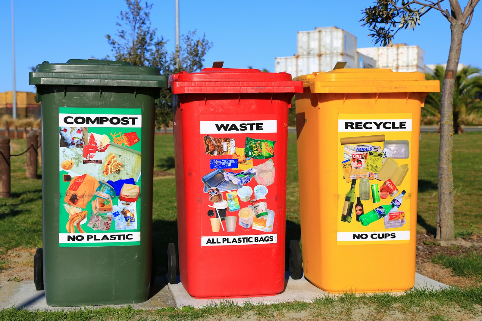 Colourful recycling bins sorted for glass, paper and plastic